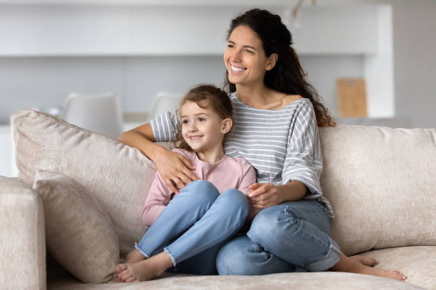 istock Happy Hispanic mom and biracial daughter dreaming 1324096487