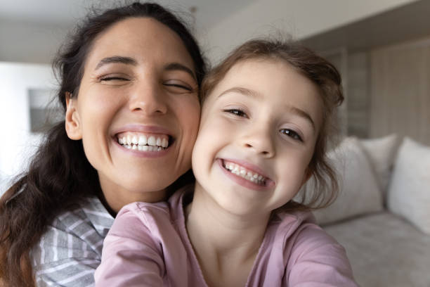 istock Smiling Hispanic mom and daughter make selfie together 1324096501