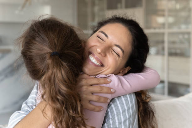 istock Small ethnic daughter hug happy Hispanic mom 1324096505