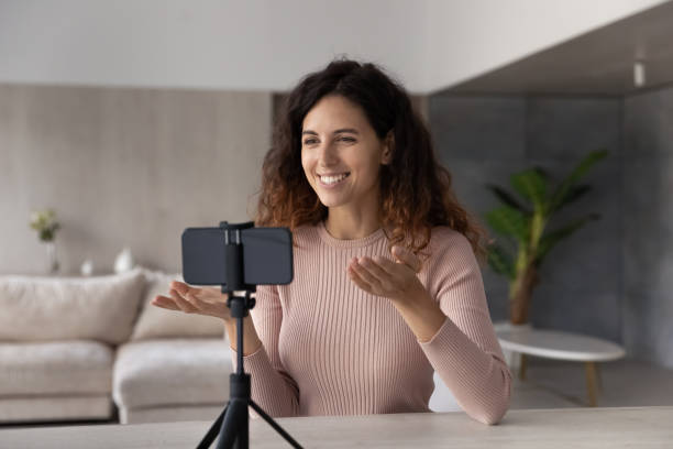 istock Smiling Hispanic woman talk on cellphone video call 1324096571