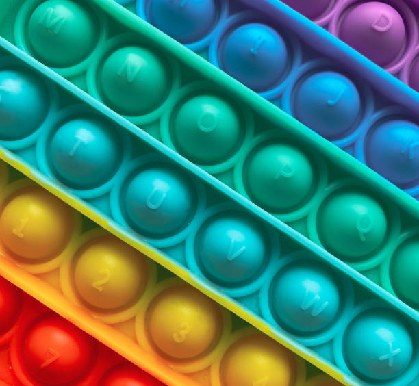 istock Closeup texture rainbow antistress finger push toy for kids pop it. 1324102671