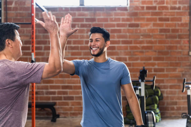 istock Two men high five after exercising at gym 1324103257