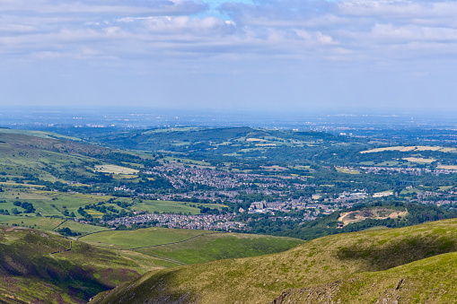 View from the Peaks, near Snake Road, of the town of Glossop, looking west with Manchester just visible in the far distance.