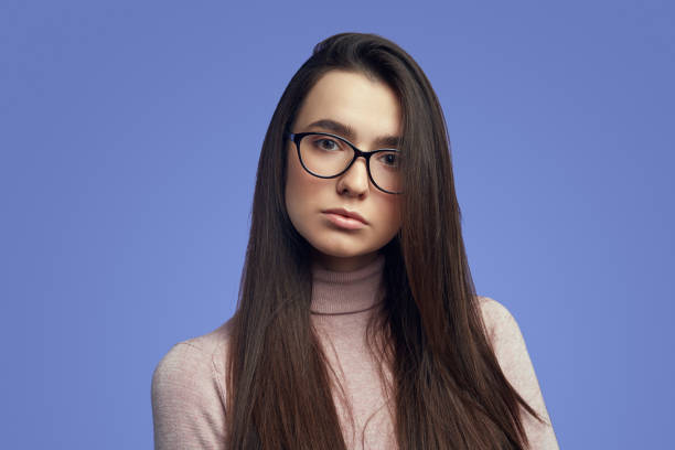 istock Girl with displeased expression, curves lips and looks with sad expression 1324104752
