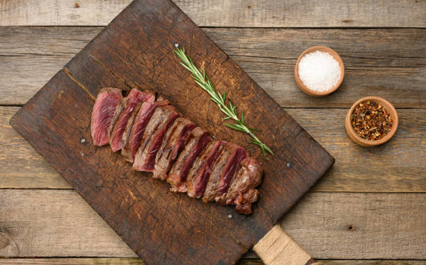 istock classic beef steak uncooked meat ,fried outside, red inside, with red juice, cut into pieces 1324107098