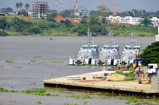 Plateau, Abidjan, Ivory Coast / Côte d'Ivoire: three Ivorian Navy patrol boats in the Autonomous Port of Abidjan, moored by Fruit Terminal / Banana Wharf, Ébrié Lagoon - RPB 33 coastal patrol boats, composite-hulled vessels built by Ufast in partnership with Raidco Marine, hulls designed by Camarc Design, armed with a 20mm canon fitted on the fore deck and two 12.7mm machine guns - Emergence (P 1401), Bouclier (P 1402) and Sékongo (P 1403). 'Marine nationale ivoirienne'.