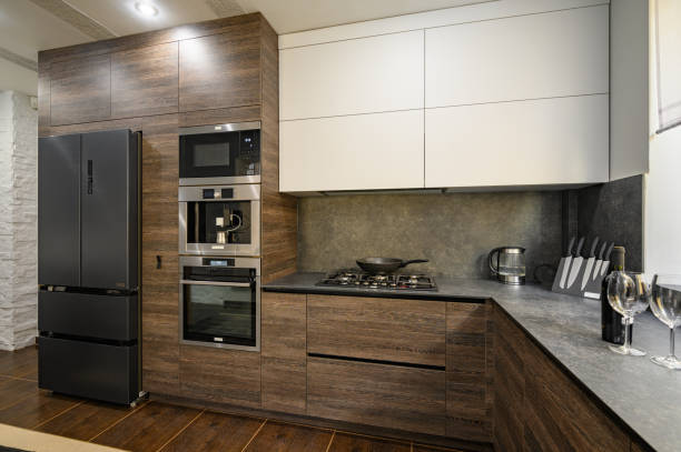 istock Modern luxury large dark brown, gray and black kitchen details 1324111507