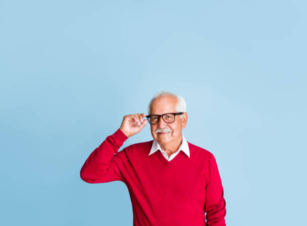 istock Happy senior man touching eyeglasses 1324116246