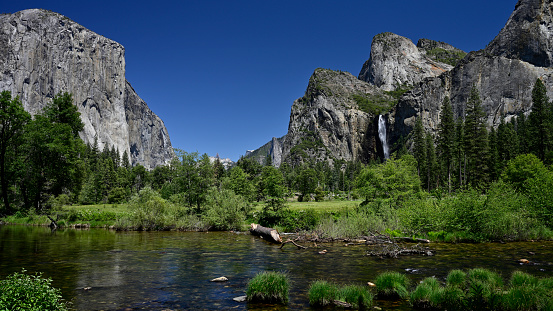 The Merced River as it passes through the Yosemite Valley with  El Capitan, Cathedral Rocks and Bridal Veil Fall in the background.