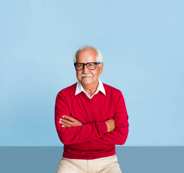 istock Senior man with arms crossed looking at camera 1324116331