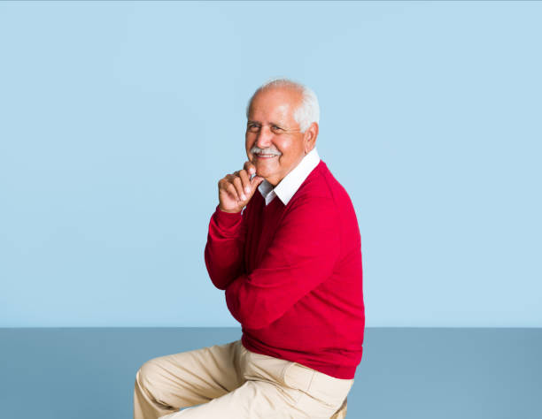 istock Lovely senior man sitting and smiling at camera 1324116350