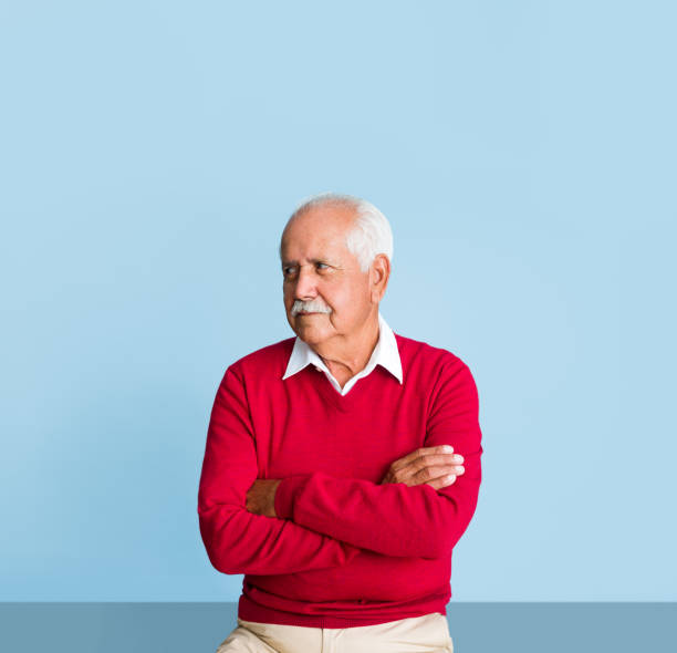 istock Senior man with arms crossed looking away 1324116873