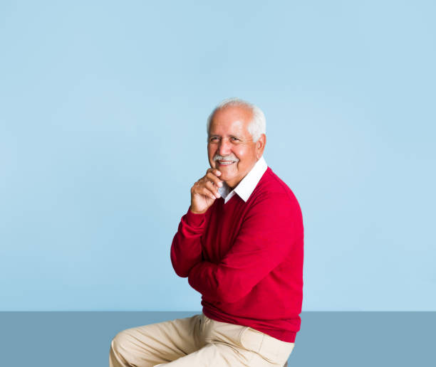 istock Cheerful senior man sitting and smiling at camera 1324116894