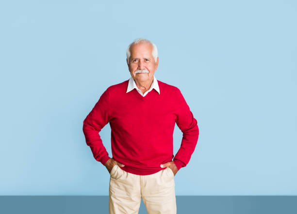 istock Senior latin man standing with hands in pockets 1324116925