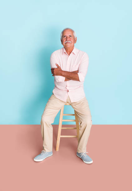 istock Lovely man sitting on stool and looking up 1324116933