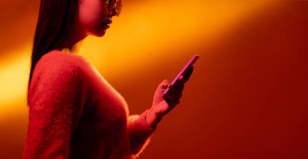 istock digital people mobile banner neon girl using phone 1324123364