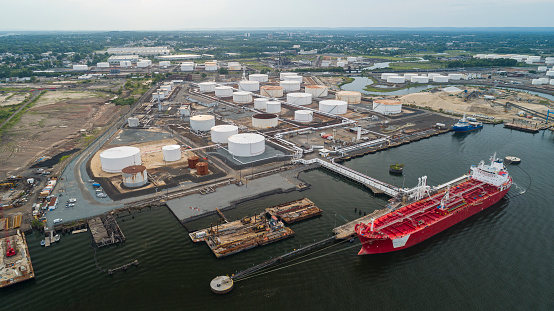 Industrial cargo ship unloading at the petroleum terminal