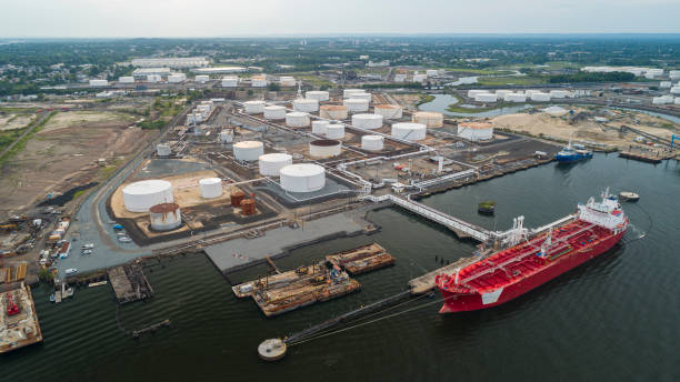 aerial view on the industrial cargo ship unloading at the petroleum terminal in new jersey, on the arthur kill tidal strait at the border with new york state. - oil tanker tanker oil sea imagens e fotografias de stock