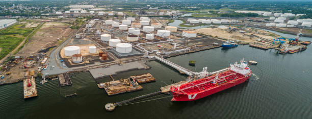 istock Drone elevated view on the industrial cargo ship unloading at the petroleum terminal in New Jersey, on the Arthur Kill tidal strait at the border with New York State. High resolution aerial stitched panorama. 1324124762