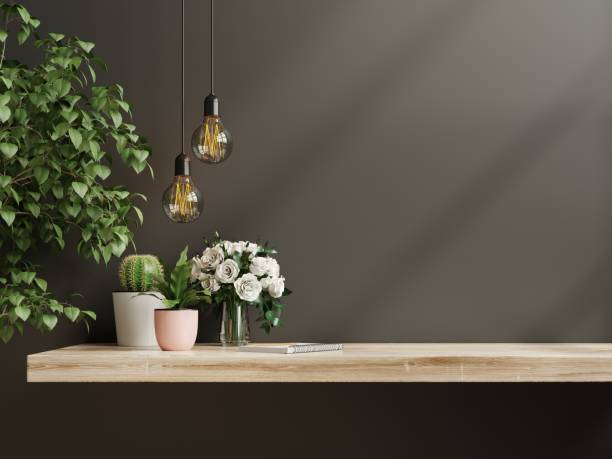 istock Interior wall mockup with green plant,Black wall and shelf. 1324130968