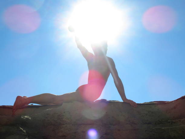 naked man punching the air in the sun - yoga nudist silhouette naked imagens e fotografias de stock