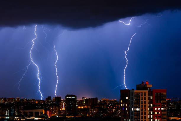 Lightning in night city Thunderstorm with lightning over the night city air attack stock pictures, royalty-free photos & images
