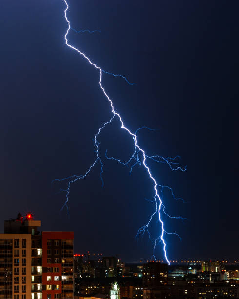 Single large lightning Single spectacular large lightning over the night city air attack stock pictures, royalty-free photos & images