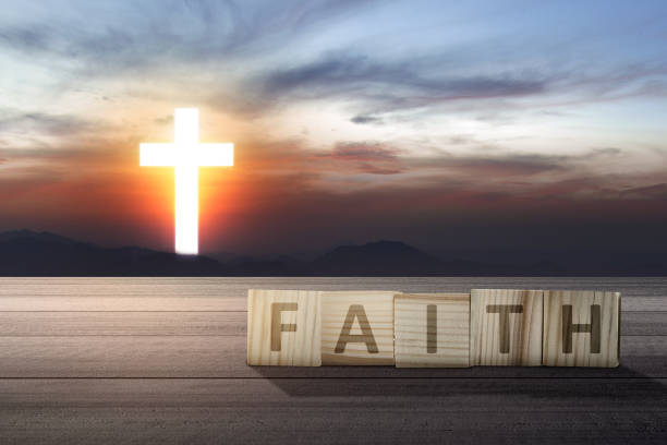 istock Faith text on wooden table with Christian cross 1324144500