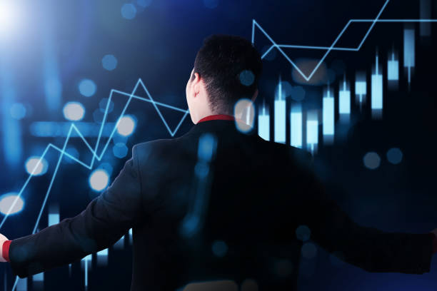 istock Rear view of Asian businessman looking a virtual bar chart 1324144652