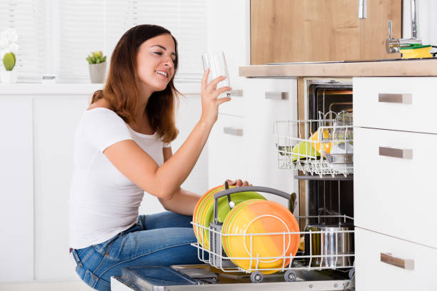 istock Woman Taking Drinking Glass From Dishwasher 1324145546