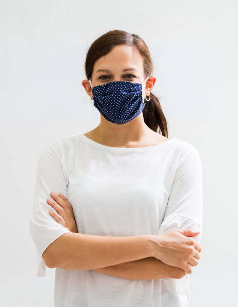 istock Woman In Reusable Cloth Face Mask 1324145586