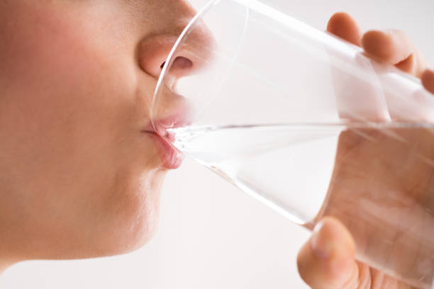 istock Thirsty Woman Drinking Water From Glass 1324146187