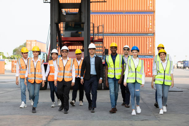 istock portrait factory workers or engineers team walking in containers warehouse storage 1324149822