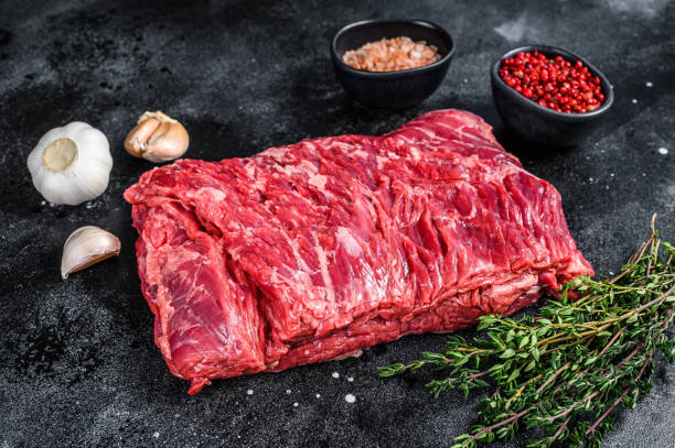 istock Raw fresh marble beef brisket meat with herbs. Black background. Top view 1324149854