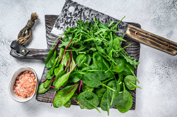 istock Fresh mixed greens, spinach, swiss chard and arugula. White background. Top view 1324150839
