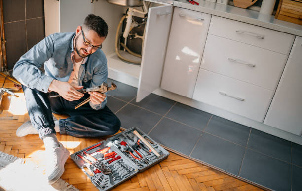 istock Male Plumber Working To Fix Leaking Sink 1324152619