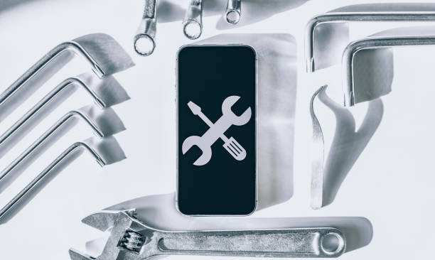 istock Phone service. Technician workplace with phone and special repairing tools. Cellphone technology device maintenance engineer. 1324153819