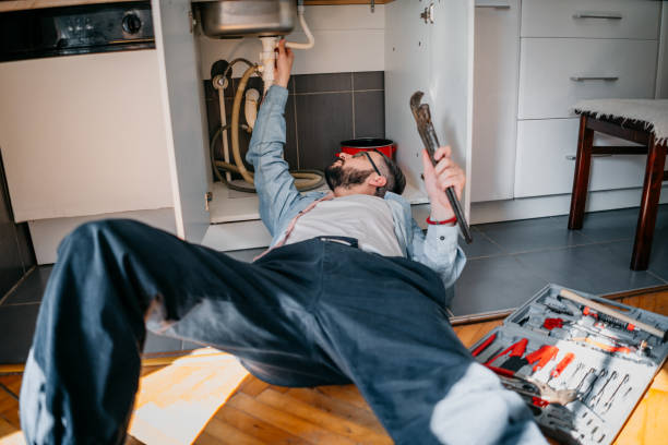 istock Male Plumber Working To Fix Leaking Sink 1324153830