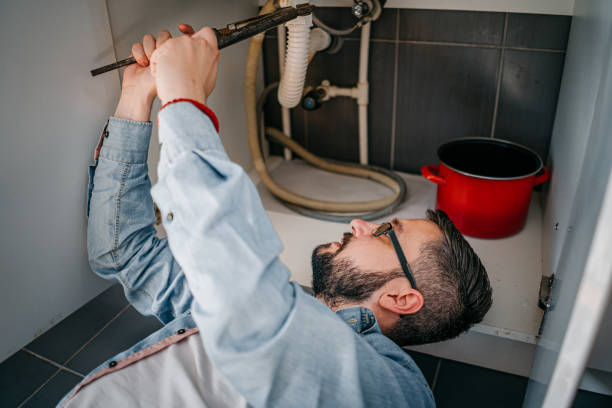 istock Male Plumber Working To Fix Leaking Sink 1324154063