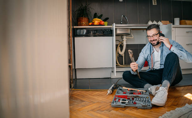 istock The plumber uses the phone 1324155866