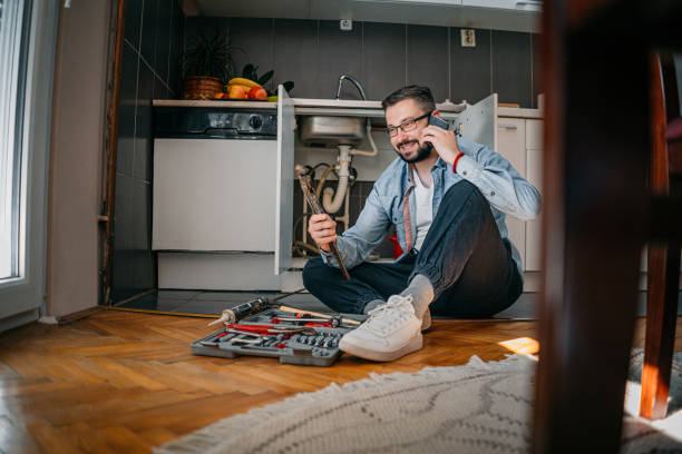 istock The plumber uses the phone 1324155948