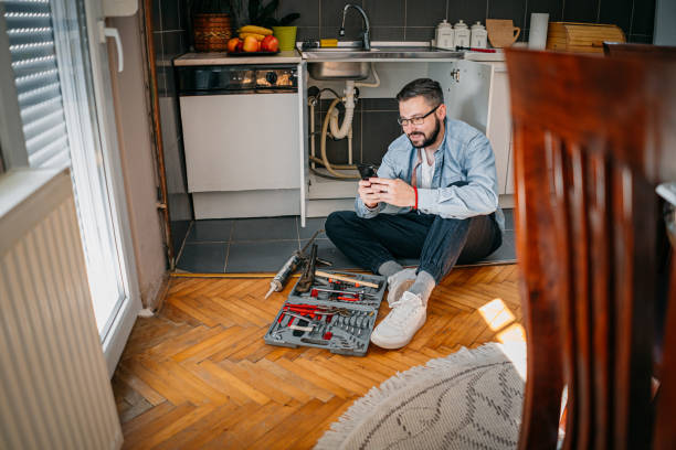 istock The plumber uses the phone 1324156159