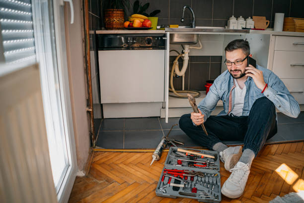 istock The plumber uses the phone 1324157062