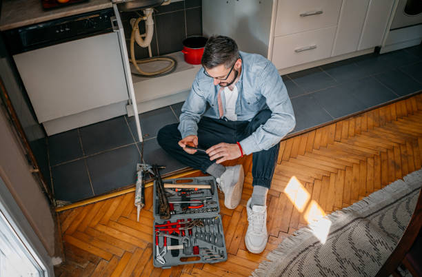 istock The plumber uses the phone 1324157165