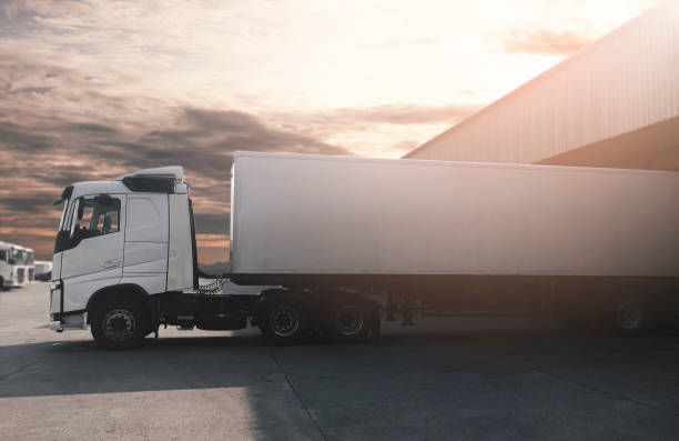istock Semi Truck Parked Loading at Dock Warehouse. Cargo Shipment. Industry Freight Truck Transportation. Shipping Warehouse Logistics. 1324158859