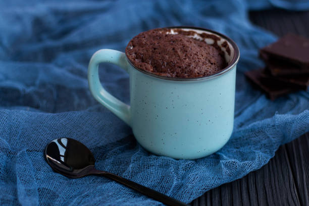 istock a chocolate cupcake in a mug is cooked in the microwave. 1324159135