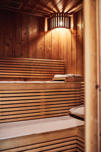 Interior of classic wooden sauna with bucket