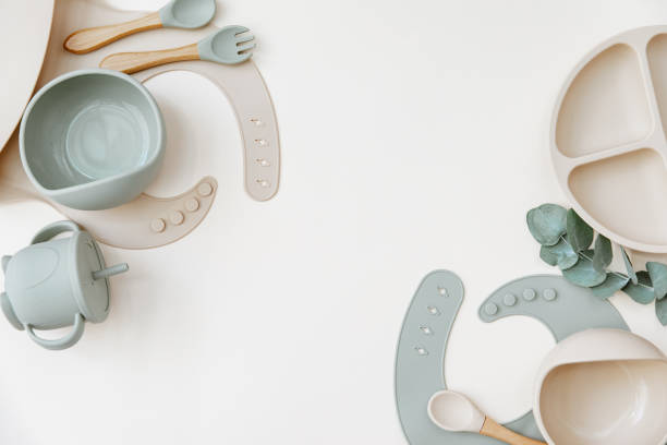 istock Baby Table Setting Background. Silicone set on light background. Place for text, copy space. Top view, flat lay. 1324162833
