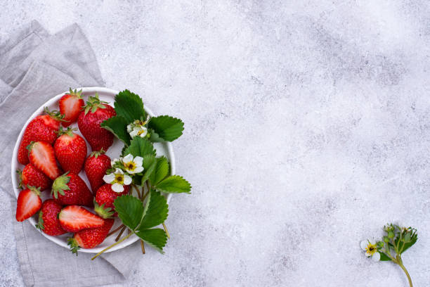 istock Strawberry with leaves and flowers 1324163187