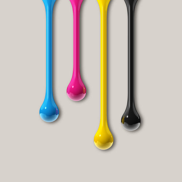 istock cmyk ink drops on grey paper square background 1324166442
